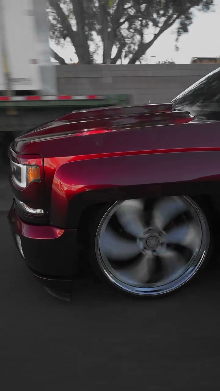Deep candy-red fender over a spinning chrome wheel