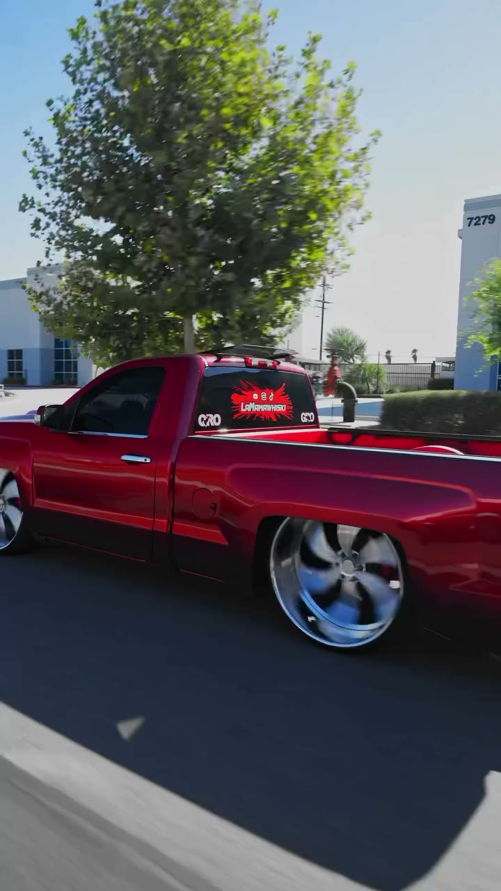Side profile of the lowered candy-red Silverado