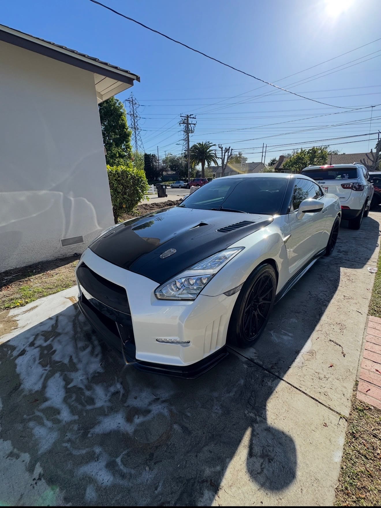 White Nissan GT-R R35 with carbon hood, paint protection film