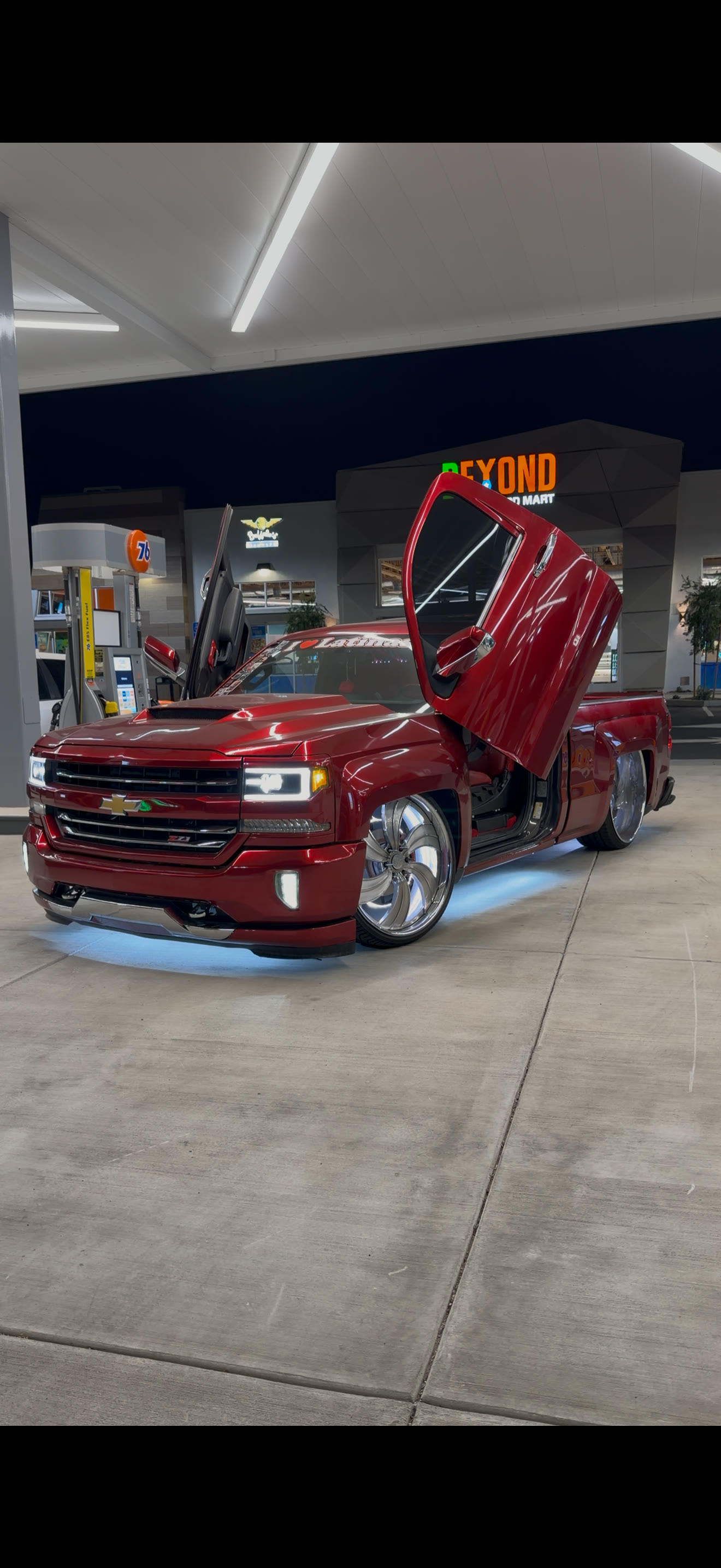 Red custom Chevy Silverado with lambo doors, vinyl wrap